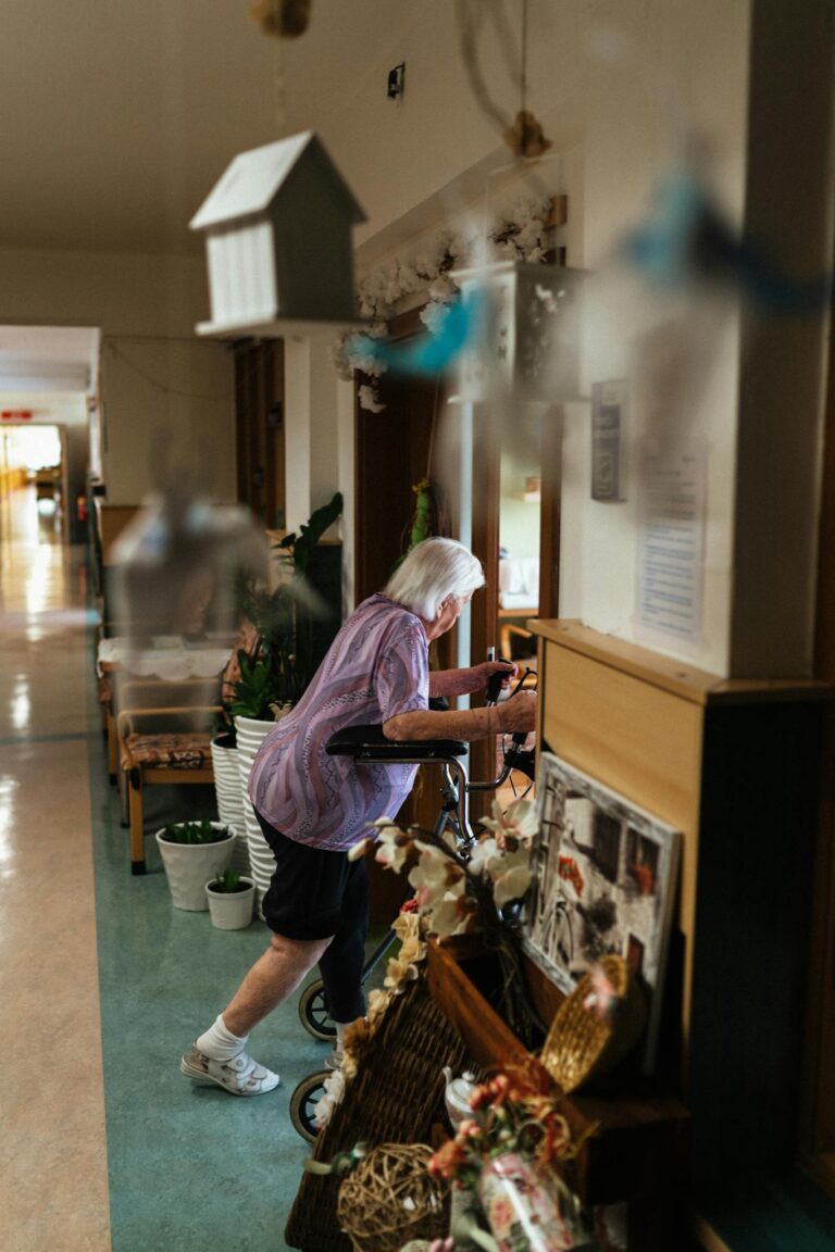Senior woman using walker in a cozy retirement home hallway, captured candidly.
